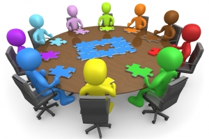 Group Of Colorful And Diverse People Holding A Meeting And Trying To Solve A Jigsaw Around A Large Rectangular Conference Table In An Office Clipart Illustration Image